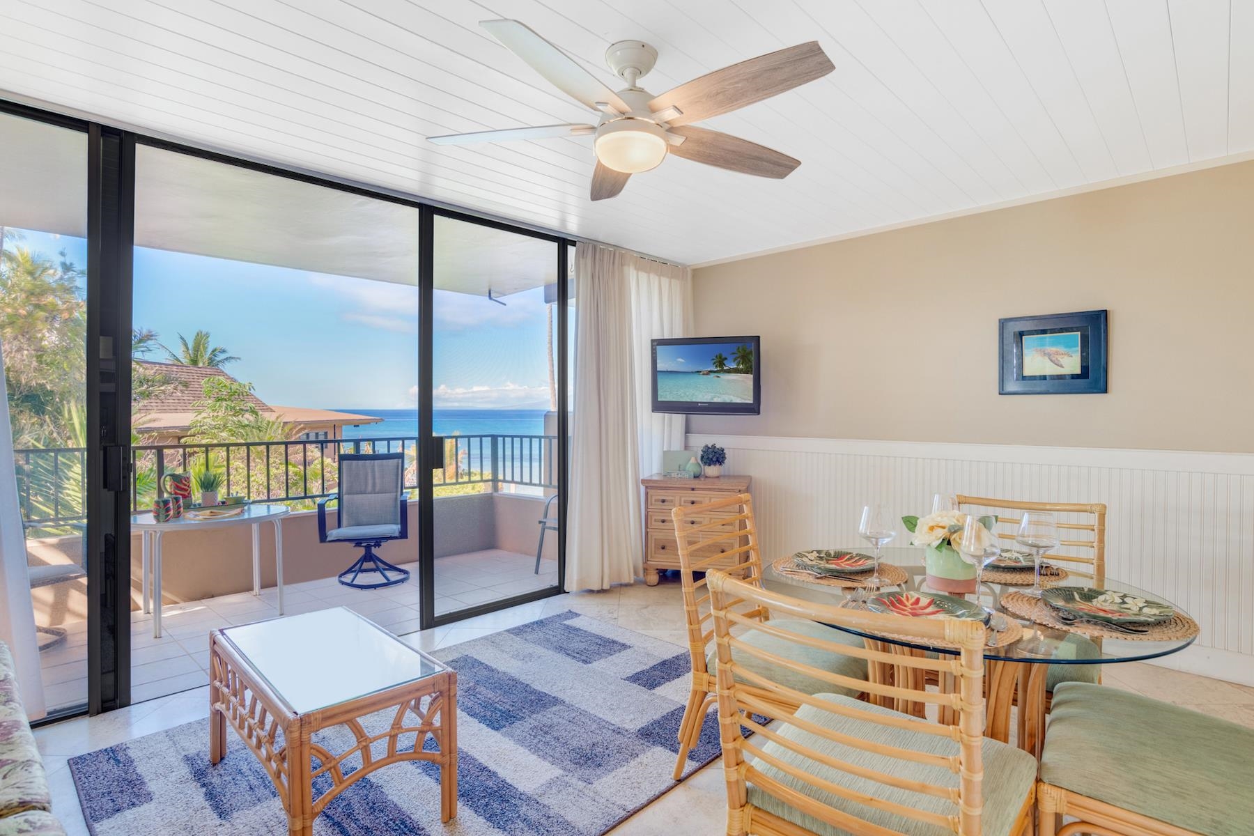 a living room with furniture and a floor to ceiling window