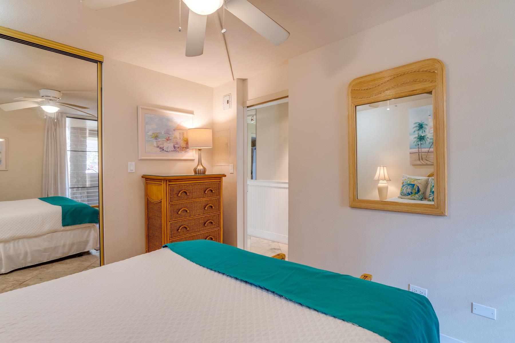 3601 Lower Honoapiilani Road, Unit 210 Lahaina, HI 96761 - Photo 20 of 25 a bedroom with a bed and a mirror
