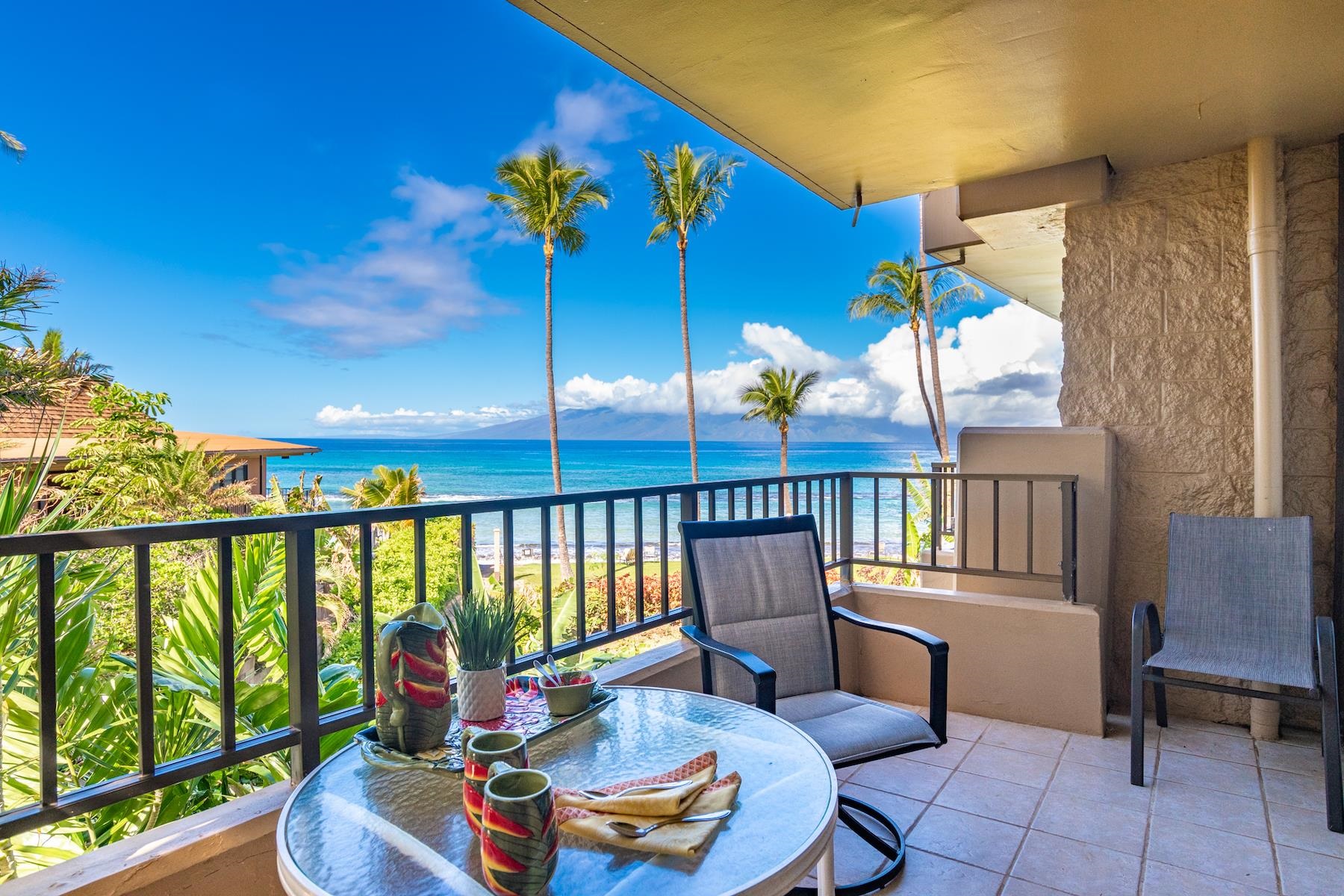 3601 Lower Honoapiilani Road, Unit 210 Lahaina, HI 96761 - Photo 2 of 25 a balcony with table and chairs