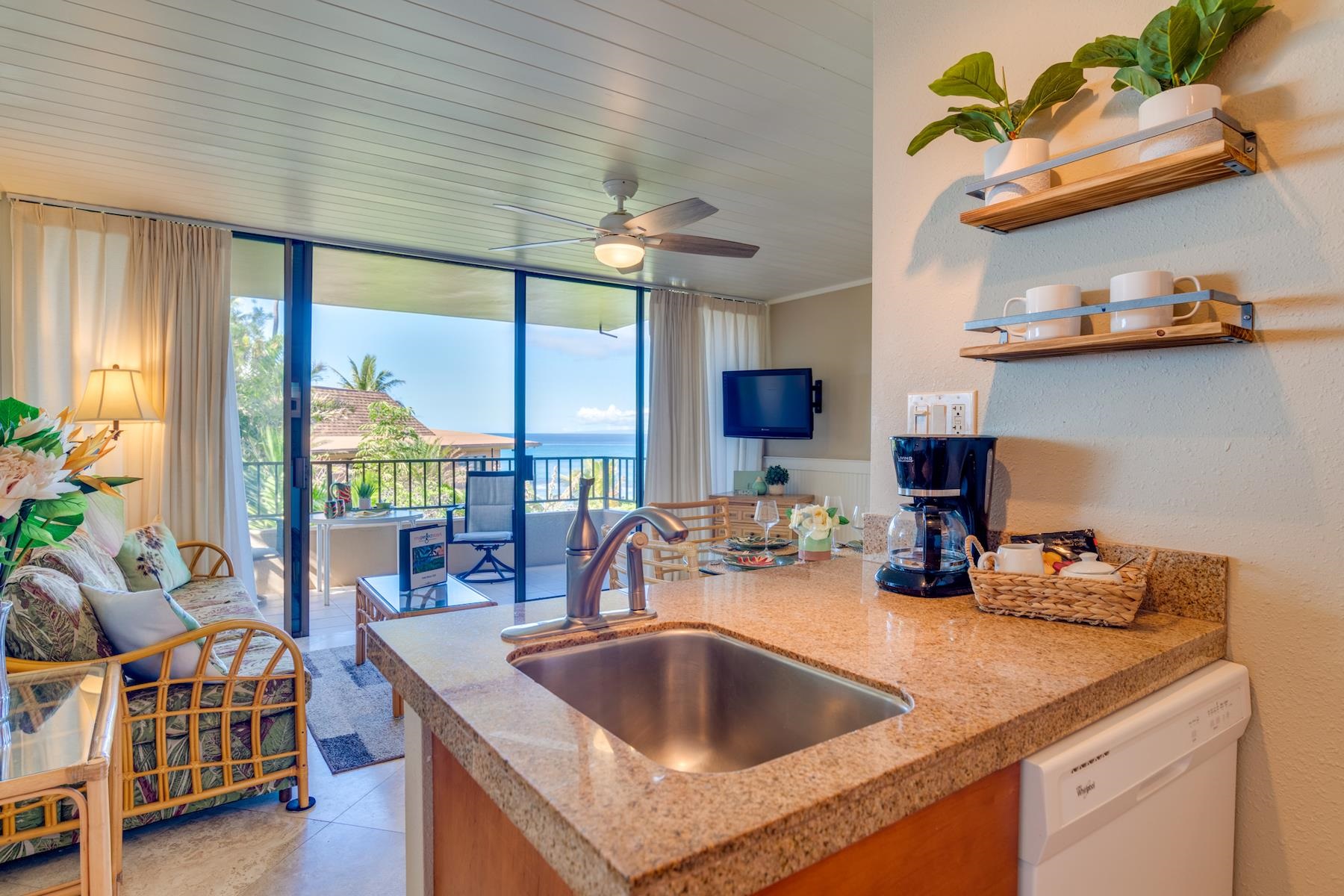 3601 Lower Honoapiilani Road, Unit 210 Lahaina, HI 96761 - Photo 4 of 25 a kitchen with stainless steel appliances granite countertop a sink a stove and a wooden floors
