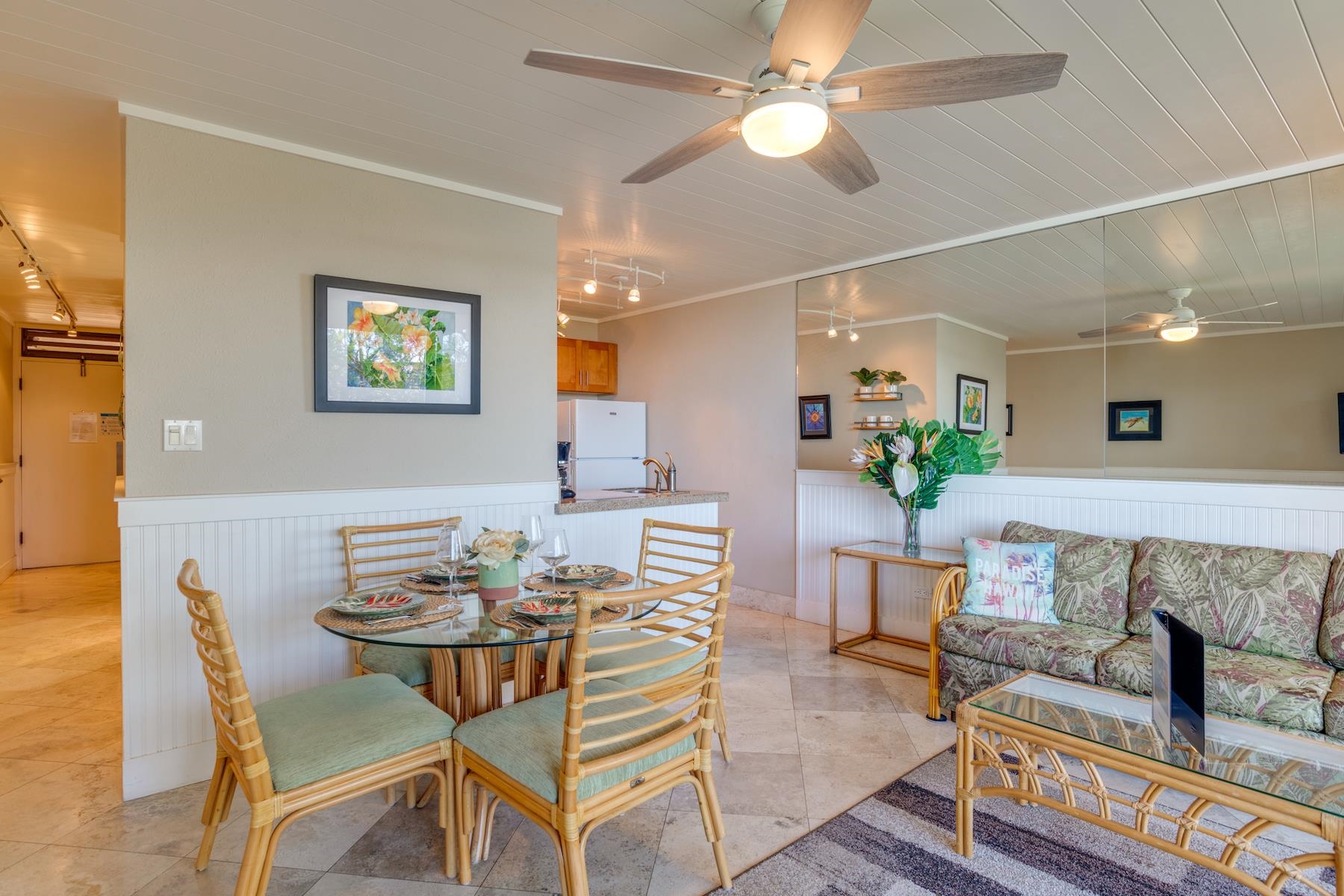 3601 Lower Honoapiilani Road, Unit 210 Lahaina, HI 96761 - Photo 9 of 25 a view of a dining room with furniture and a chandelier
