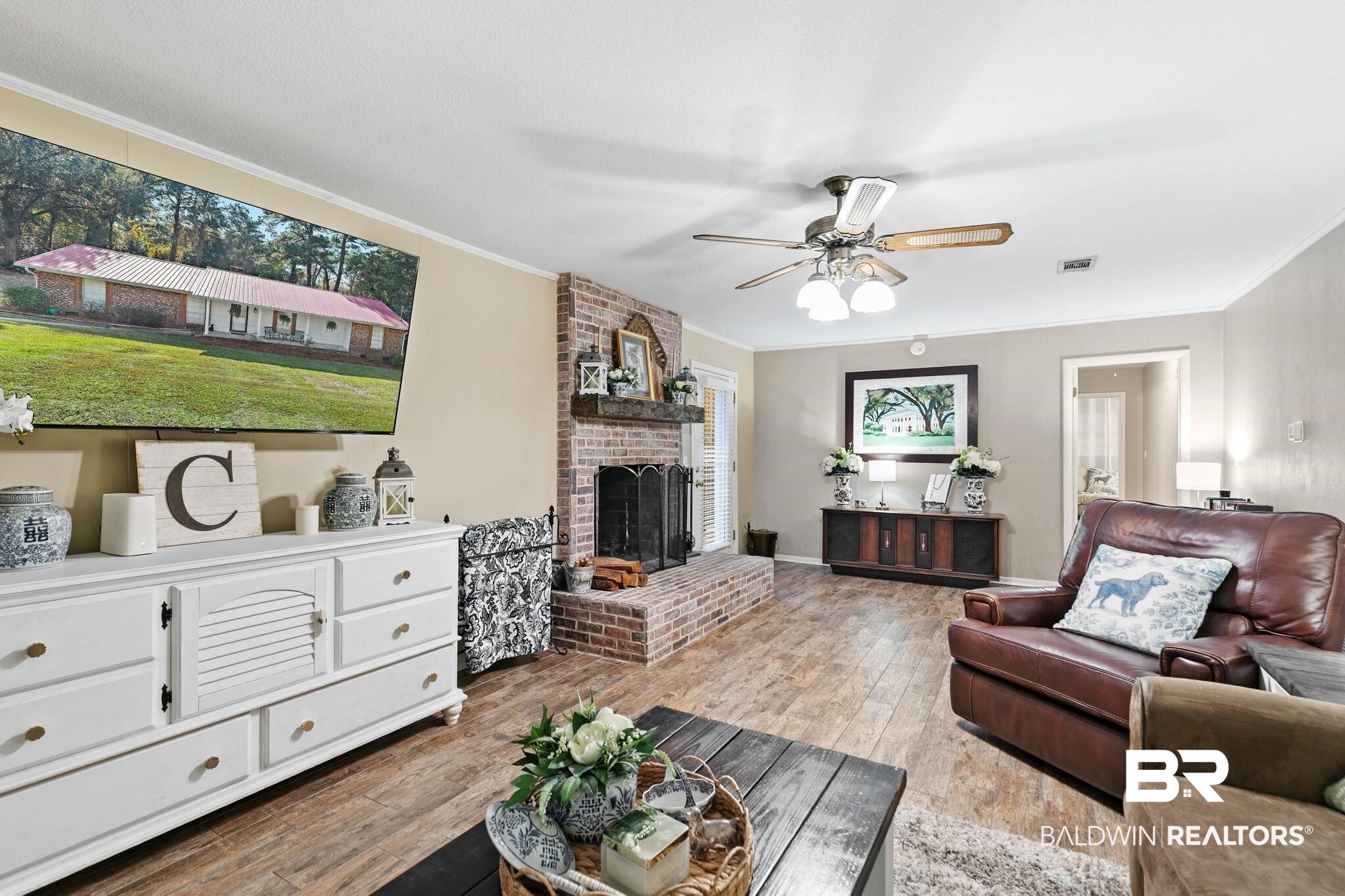 4 Rally Road Spanish Fort, AL 36527 - Photo 15 of 41 Living area featuring ornamental molding, wood finished floors, a brick fireplace, and a ceiling fan