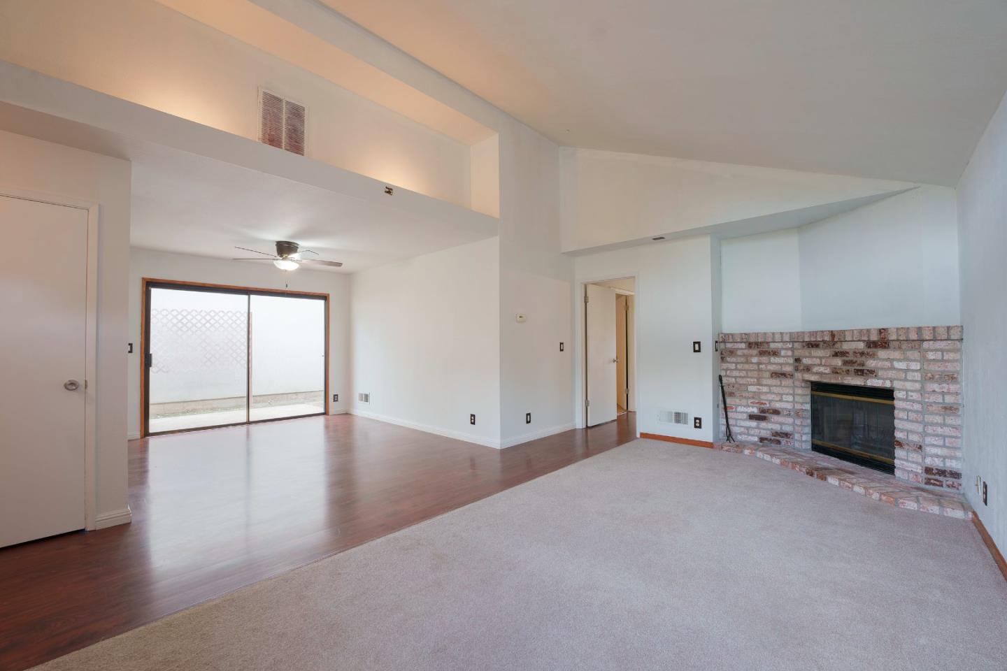 1549 North First Street Salinas, CA 93906 - Photo 13 of 25 an empty room with wooden floor fireplace and windows
