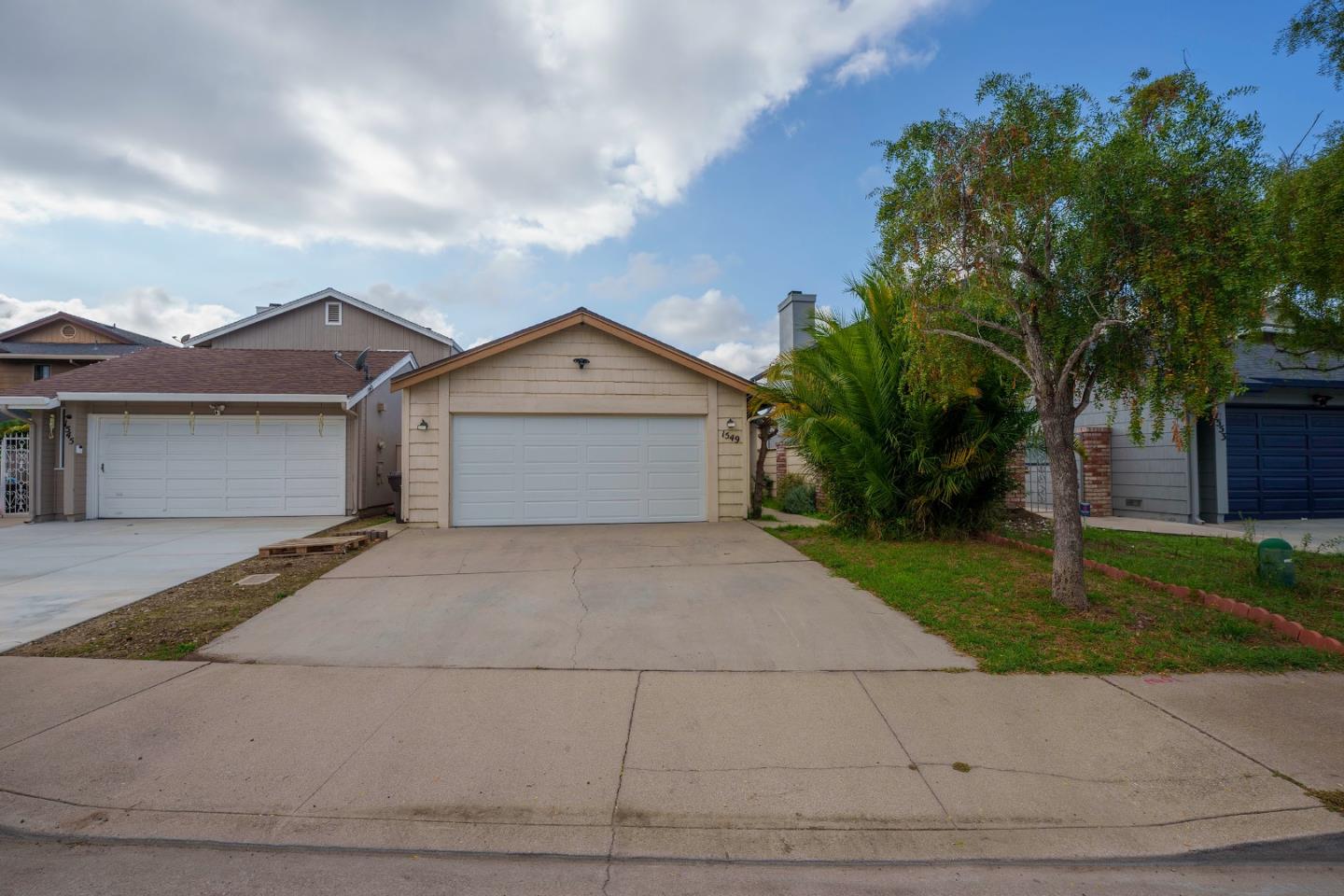 1549 North First Street Salinas, CA 93906 - Photo 2 of 25 a front view of a house with a yard and a garage