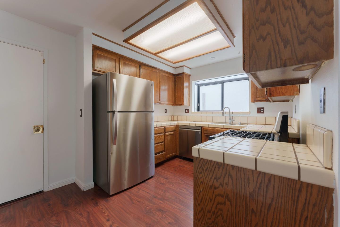 1549 North First Street Salinas, CA 93906 - Photo 7 of 25 a kitchen with a refrigerator sink and cabinets
