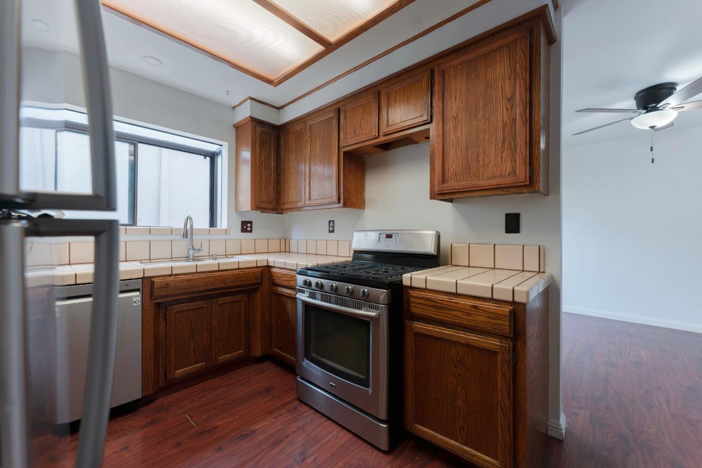 1549 North First Street Salinas, CA 93906 - Photo 9 of 25 a kitchen with stainless steel appliances granite countertop a stove a sink and a refrigerator
