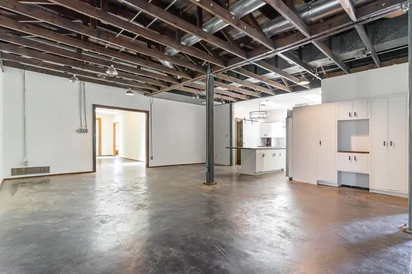 a view of empty room with wooden floor and windows