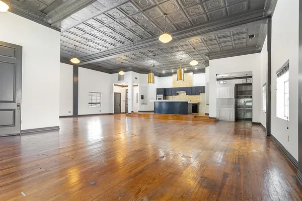 a view of a livingroom with furniture and a kitchen