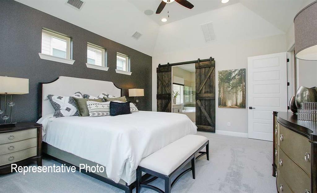 2845 Taylor Trail Corinth, TX 76210 - Photo 7 of 14 Vaulted ceiling room featuring barn-style sliding doors, recessed lighting, and a ceiling fan
