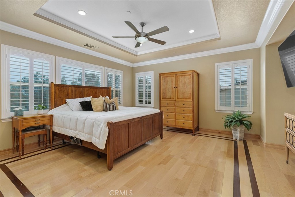 13337 Hunt Club Drive Rancho Cucamonga, CA 91739 - Photo 21 of 45 Primary bedroom with ceiling fan and shutters