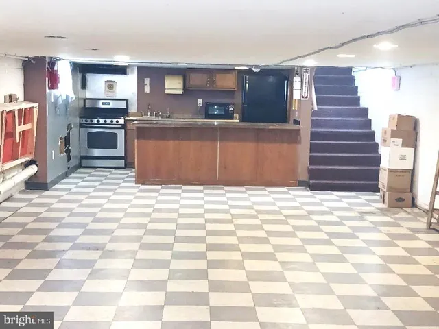 a view of a kitchen with kitchen appliances and cabinets