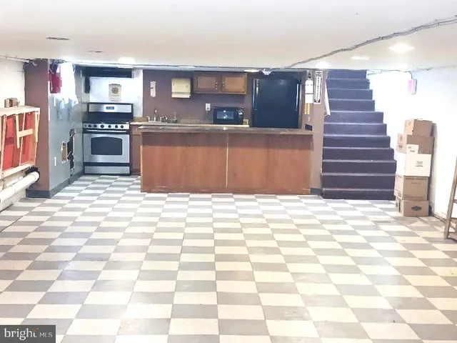 a view of a kitchen with kitchen appliances and cabinets