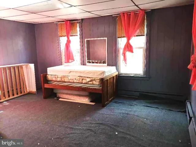 a bed sitting in a room next to a window