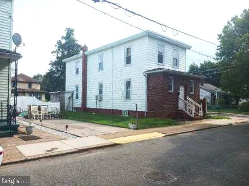 a view of backyard of house with garage