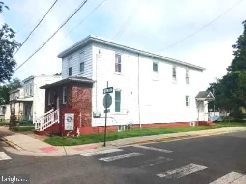 a view of a house with a yard and garage