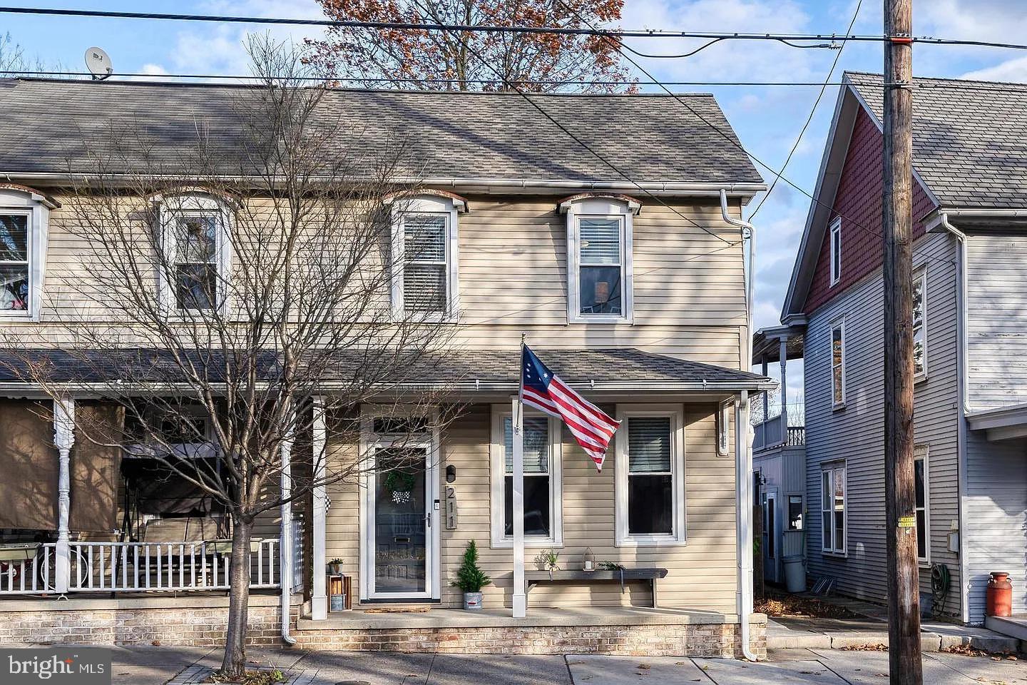 a view of a white house with large windows