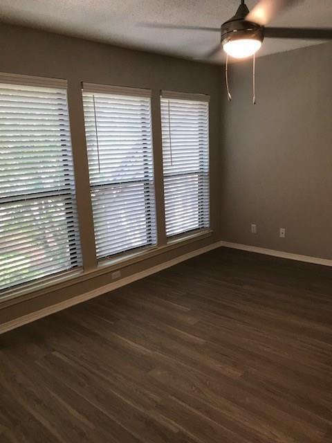 18240 Midway Road, Unit 303 Dallas, TX 75287 - Photo 13 of 22 Unfurnished room with a ceiling fan, dark wood-type flooring, and a textured ceiling