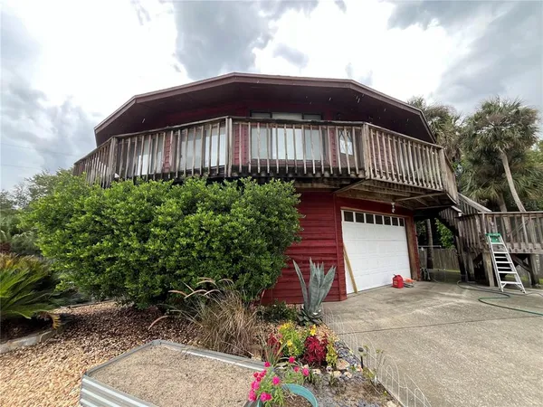 a view of a wooden house with a yard