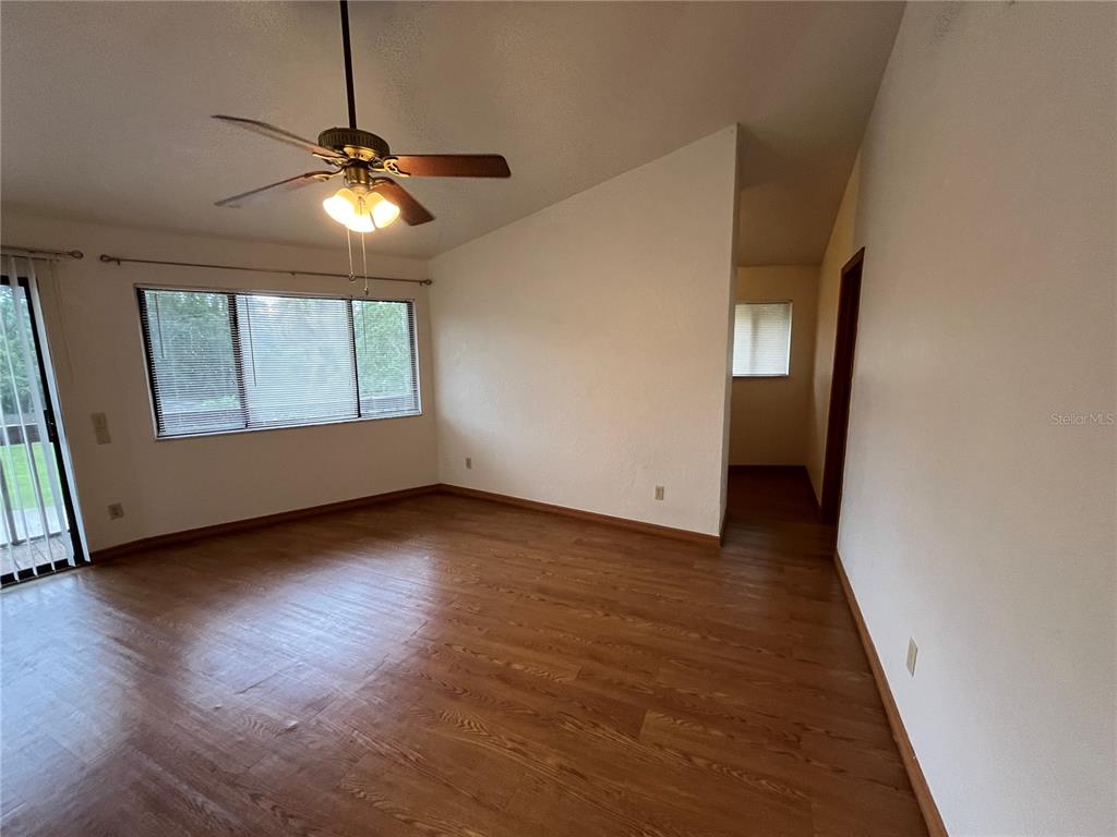 6560 Timberlane Road Lake Wales, FL 33898 - Photo 11 of 31 a view of a livingroom with wooden floor and a ceiling fan