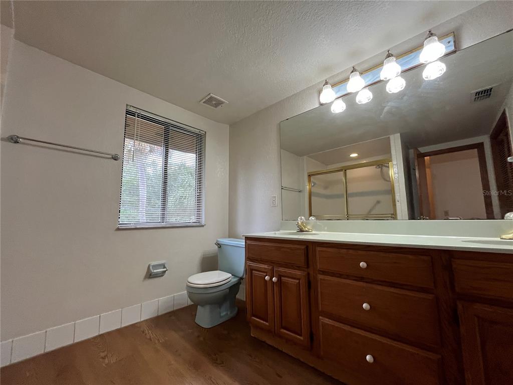 6560 Timberlane Road Lake Wales, FL 33898 - Photo 12 of 31 a spacious bathroom with a granite countertop sink a toilet and a mirror