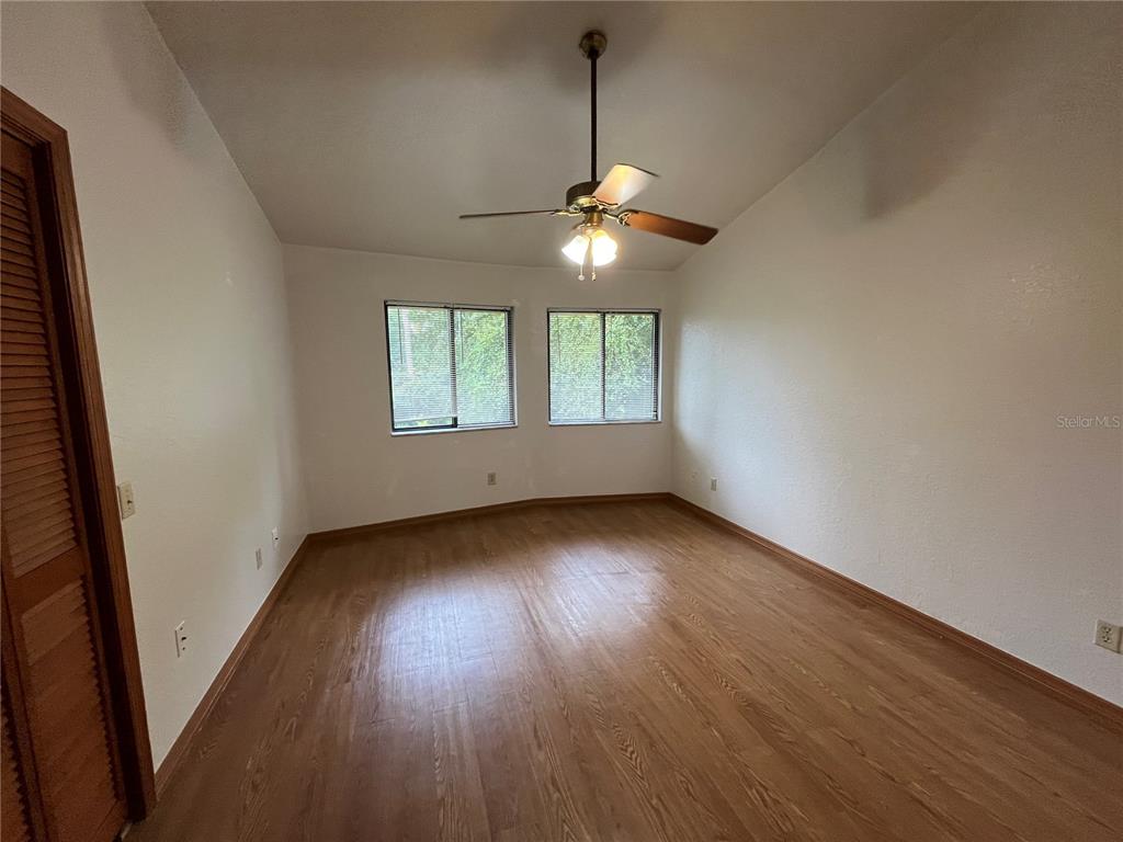 6560 Timberlane Road Lake Wales, FL 33898 - Photo 15 of 31 an empty room with wooden floor and windows
