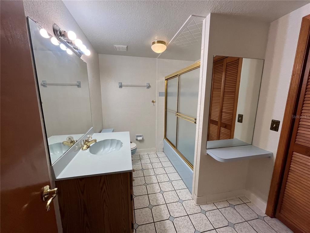 6560 Timberlane Road Lake Wales, FL 33898 - Photo 17 of 31 a bathroom with a sink a mirror and a shower