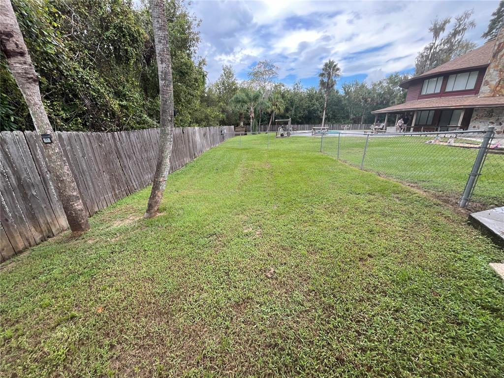 6560 Timberlane Road Lake Wales, FL 33898 - Photo 30 of 31 a view of a backyard with a garden and entertaining space