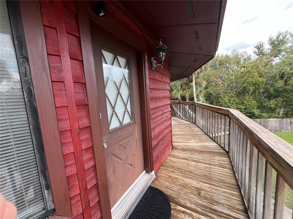 6560 Timberlane Road Lake Wales, FL 33898 - Photo 4 of 31 a view of a balcony with wooden floor and stairs
