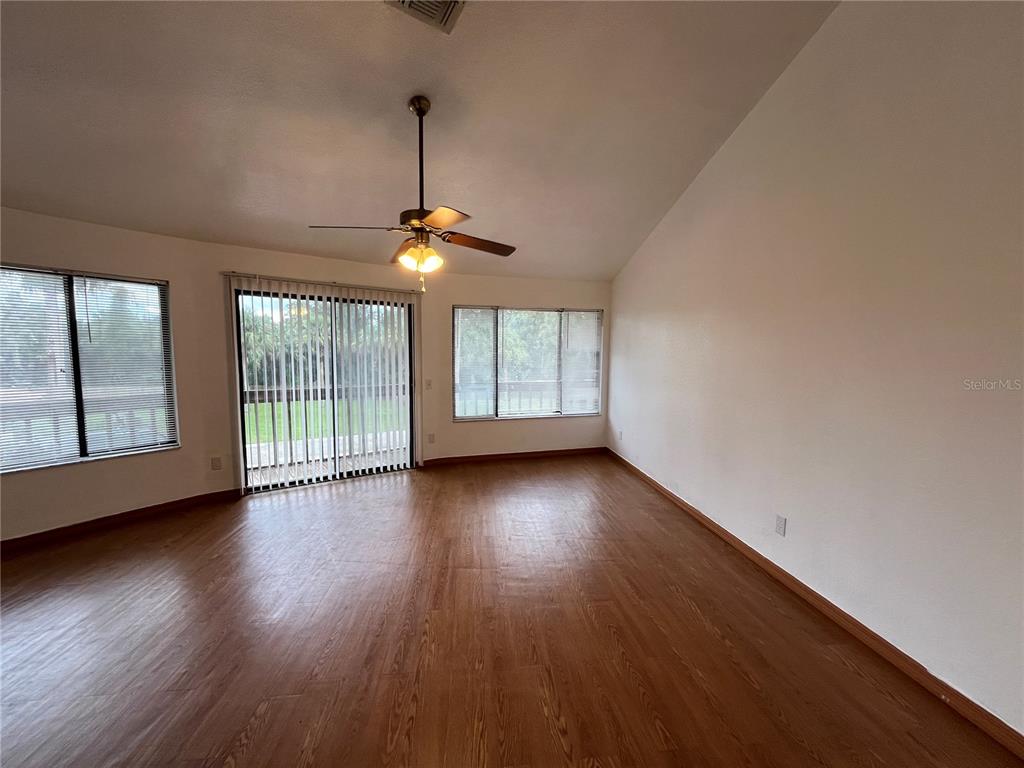 6560 Timberlane Road Lake Wales, FL 33898 - Photo 6 of 31 a view of an empty room with wooden floor and a window