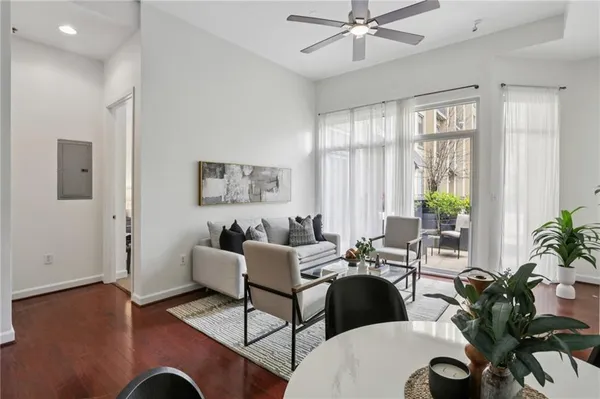 a living room with furniture and wooden floor