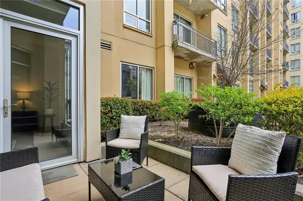 a balcony with furniture and a potted plant