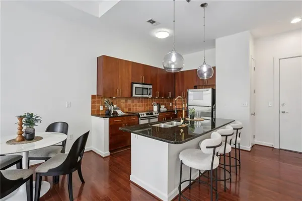 a view of a dining room with furniture and wooden floor
