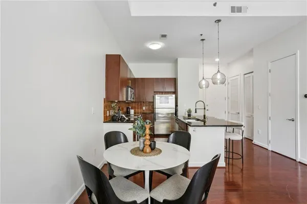 a kitchen with a sink a counter space and cabinets
