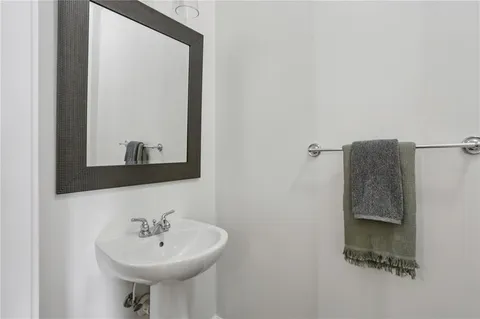 a dining room with wooden floor a chandelier a wooden table and chairs