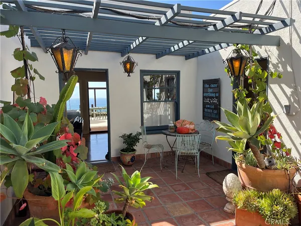 a outdoor living space with lots of potted plants