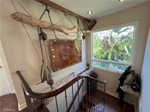 a view of a room with furniture and wooden floor