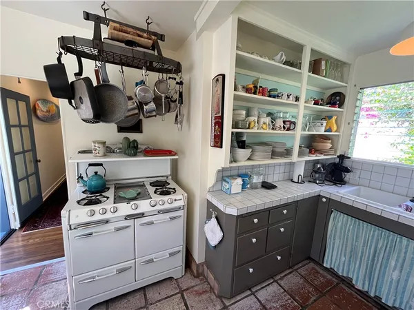 a kitchen with stainless steel appliances a sink and cabinets