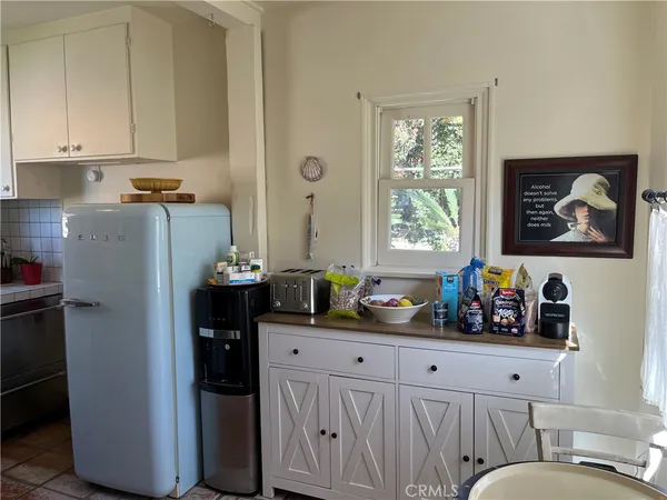 a kitchen with stainless steel appliances a refrigerator sink and cabinets