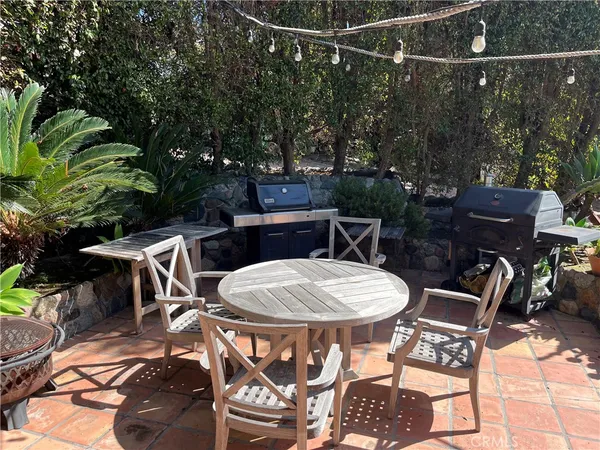 a view of a patio with a table and chairs