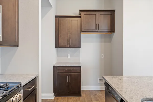a kitchen with granite countertop a stove and a sink