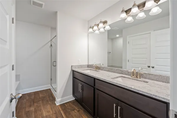 a bathroom with a double vanity sink and a mirror