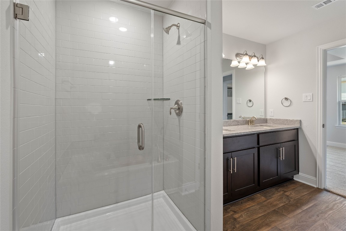 10641 Ellerston Road Cleveland, TX 77327 - Photo 22 of 34 a bathroom with a shower sink and mirror