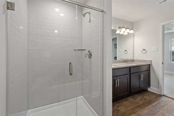a bathroom with a shower sink and mirror