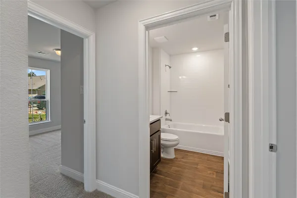 a bathroom with a granite countertop toilet a sink and bathtub