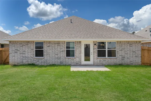 a view of a house with a yard and a large window