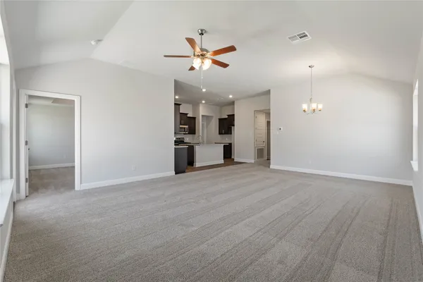 an empty room with cabinet and windows