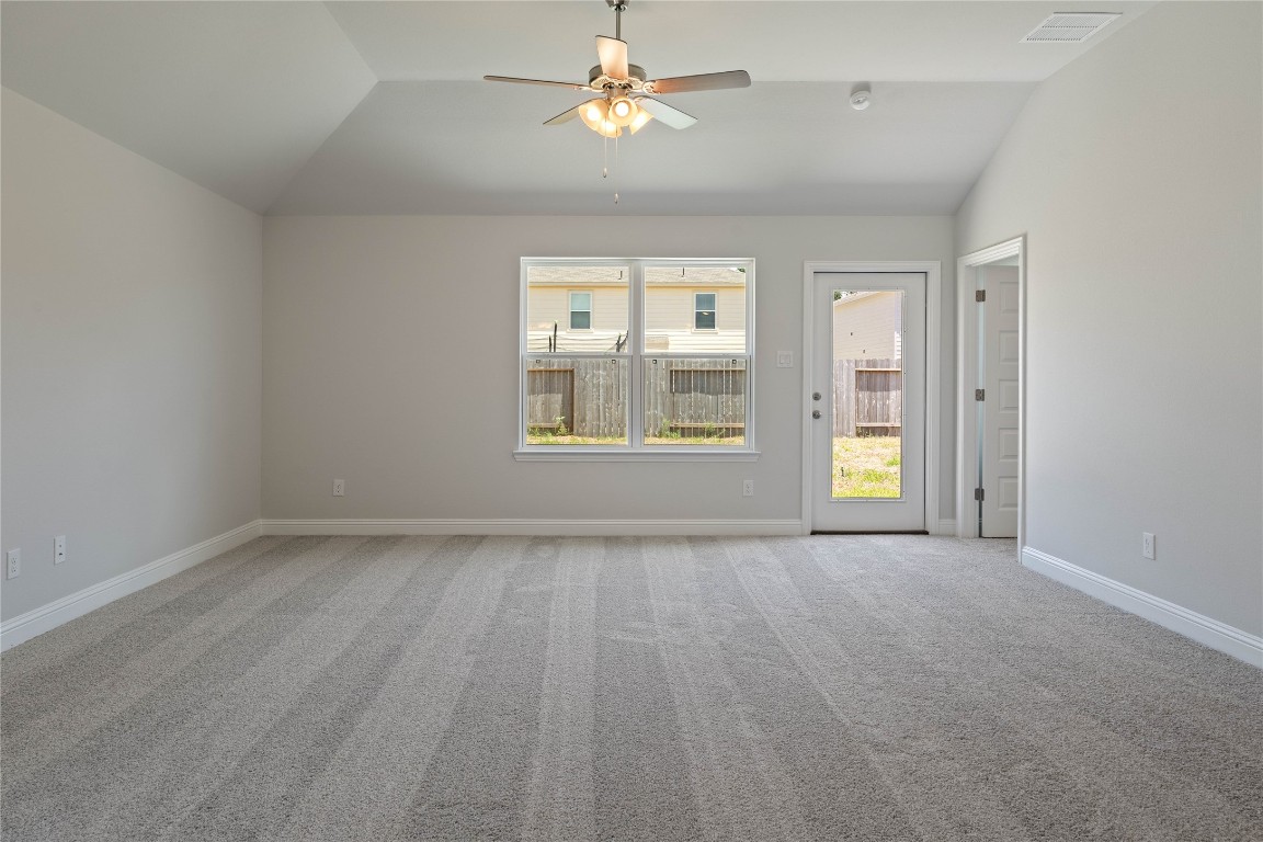 10641 Ellerston Road Cleveland, TX 77327 - Photo 7 of 34 an empty room with windows and chandelier fan