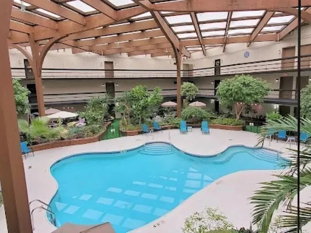 a view of a kitchen with kitchen island stainless steel appliances windows