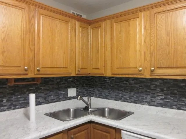 a kitchen with a sink and cabinets