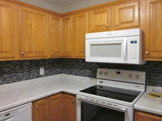 a white refrigerator freezer sitting in a kitchen